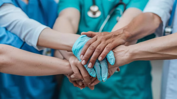 group-smiling-doctors-nurses-standingteam-medical-doctors-nurses-holding-hands-toget_1267867-477